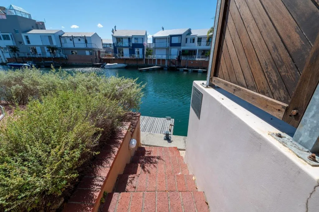 Turquoise lagoon water with waterfront homes and boats moored nearby