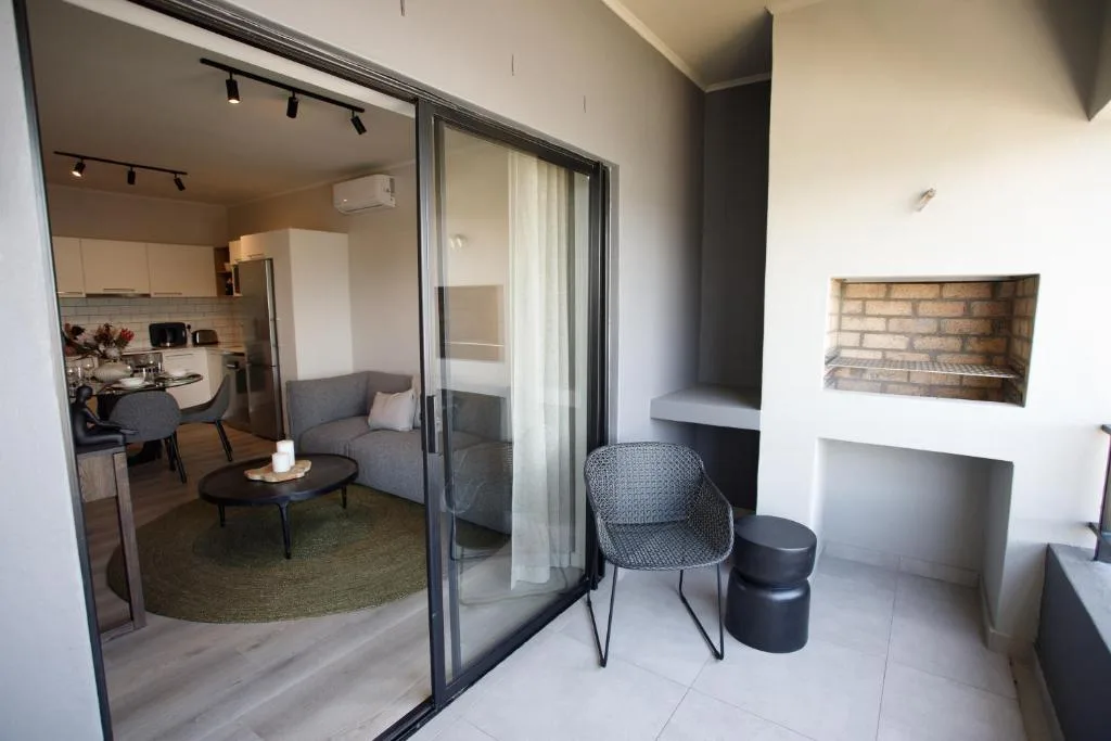 Covered patio with modern seating and sliding doors to lounge area