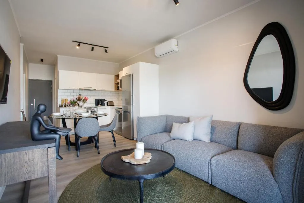 Modern lounge with gray sectional sofa and round black coffee table