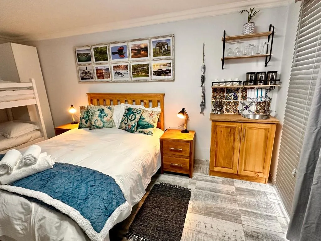Bright bedroom with double bed, wooden headboard, and cozy decor throughout