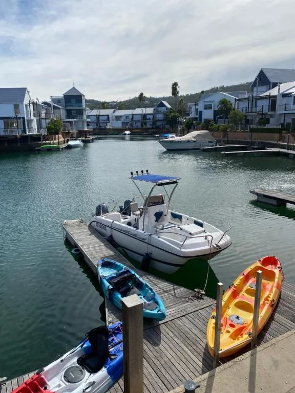 Waterfront view of boats moored at The Quays with colorful residential buildings