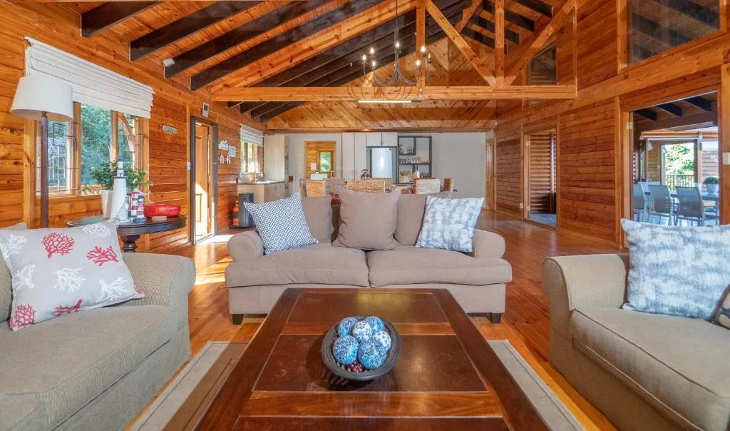 Spacious wooden lounge with comfortable sofas and coffee table