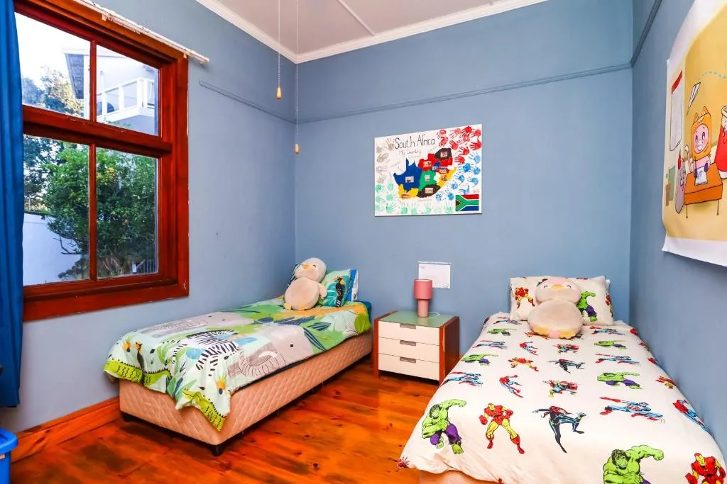 Bright children's bedroom with two single beds and colorful bedding