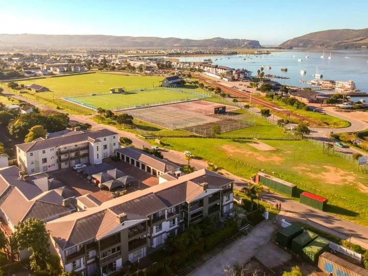 Aerial view of Knysna waterfront with lagoon, mountains, and sports facilities
