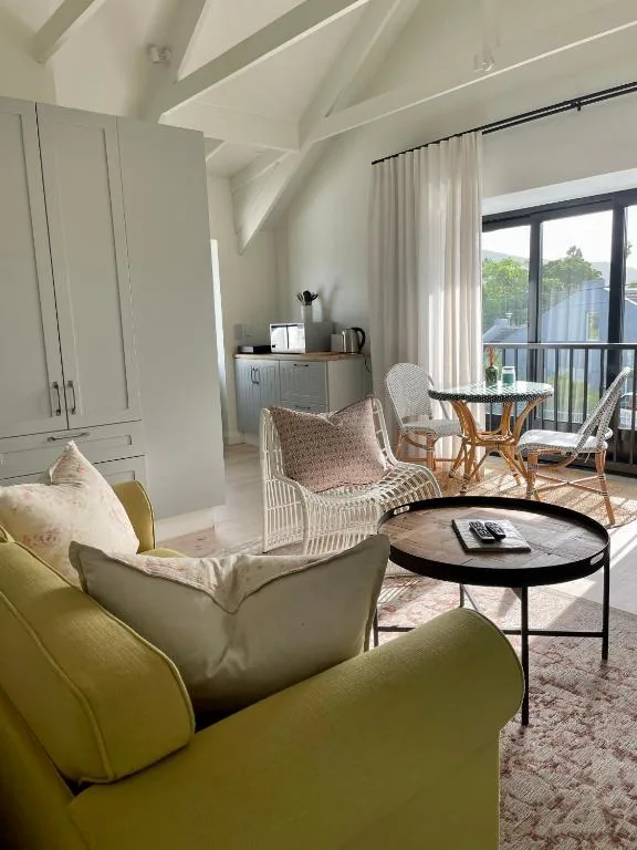 Bright living room with lime green armchair, wicker seating, and black coffee table