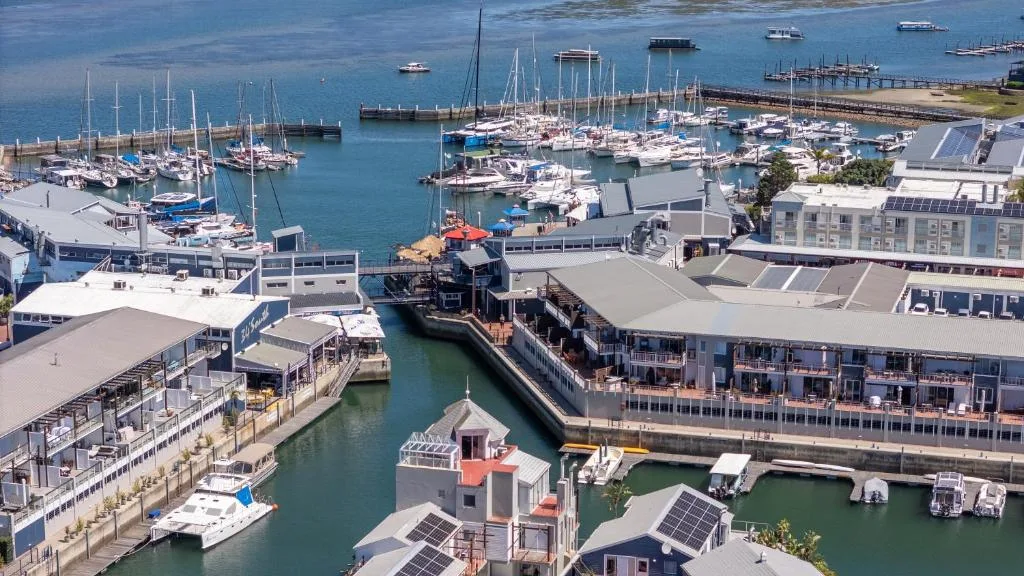 Aerial view of Knysna Waterfront marina with sailboats and coastal buildings