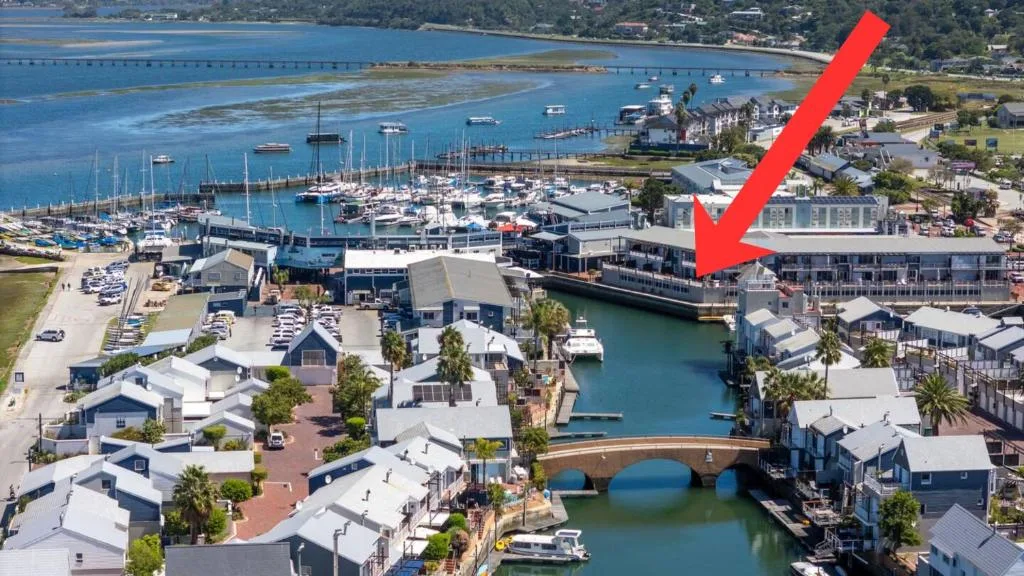 Aerial view of Knysna waterfront with lagoon, boats, and surrounding coastal town