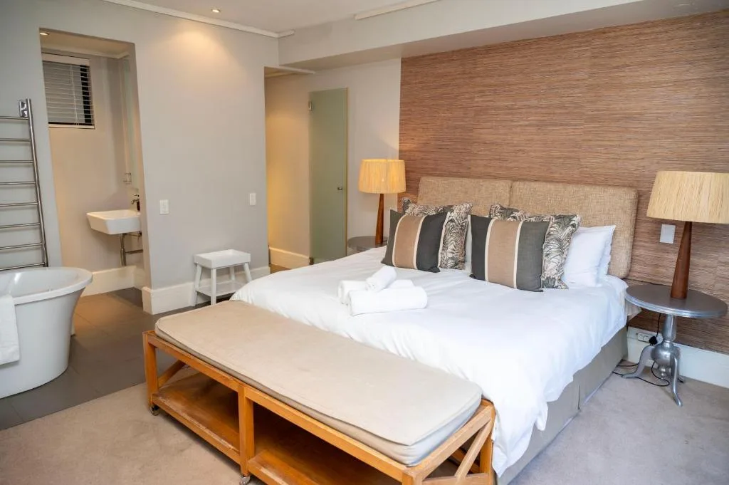 Spacious bedroom with queen bed, en-suite bathroom, and modern furnishings