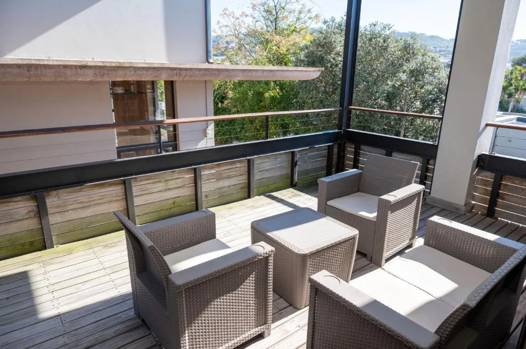 Spacious outdoor deck with wicker seating and mountain views