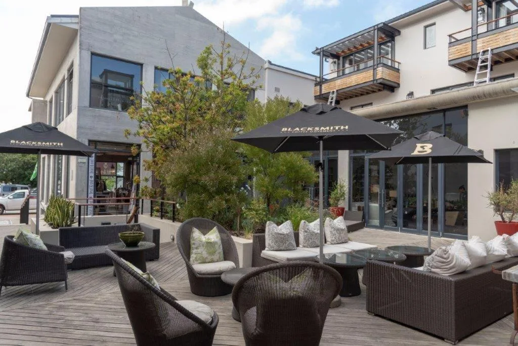 Outdoor patio with comfortable seating, umbrellas, and modern architecture