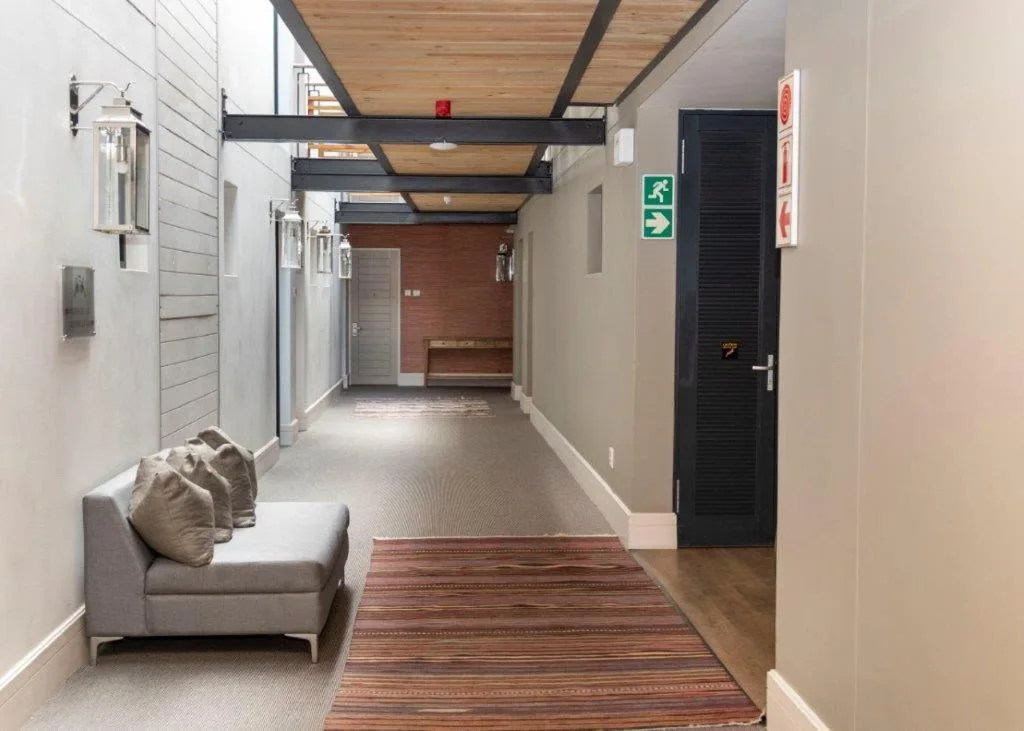 Modern hallway with seating area, wooden beams, and contemporary design elements