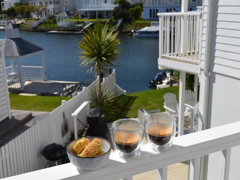 Lagoon waterfront view from balcony with coffee and pastries