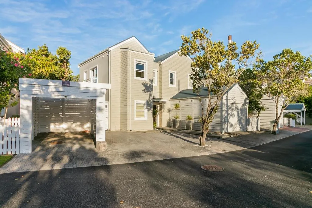 Modern white cottage with garage and landscaped front garden entrance