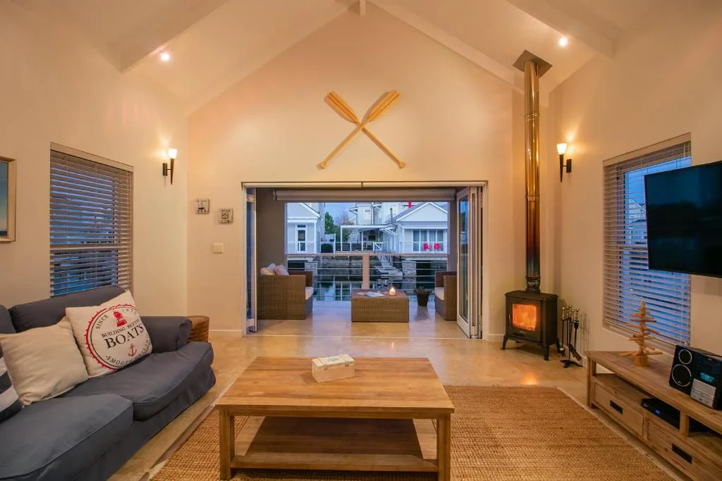 Modern lounge with sofa, wooden coffee table, and wood-burning stove