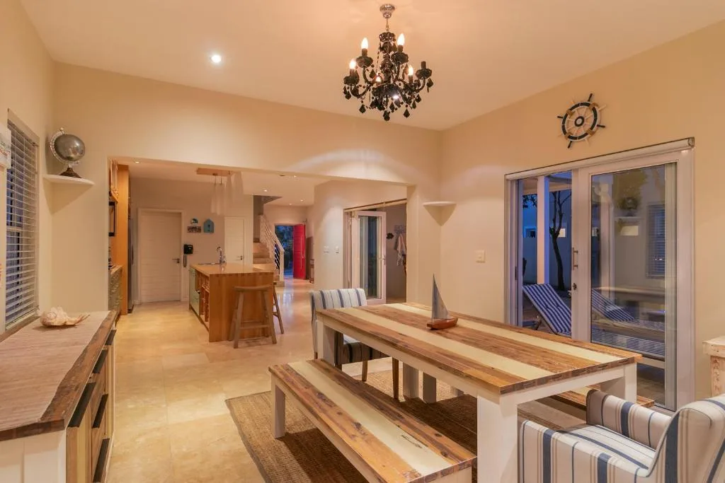 Spacious open-plan living area with wooden dining tables and upholstered seating