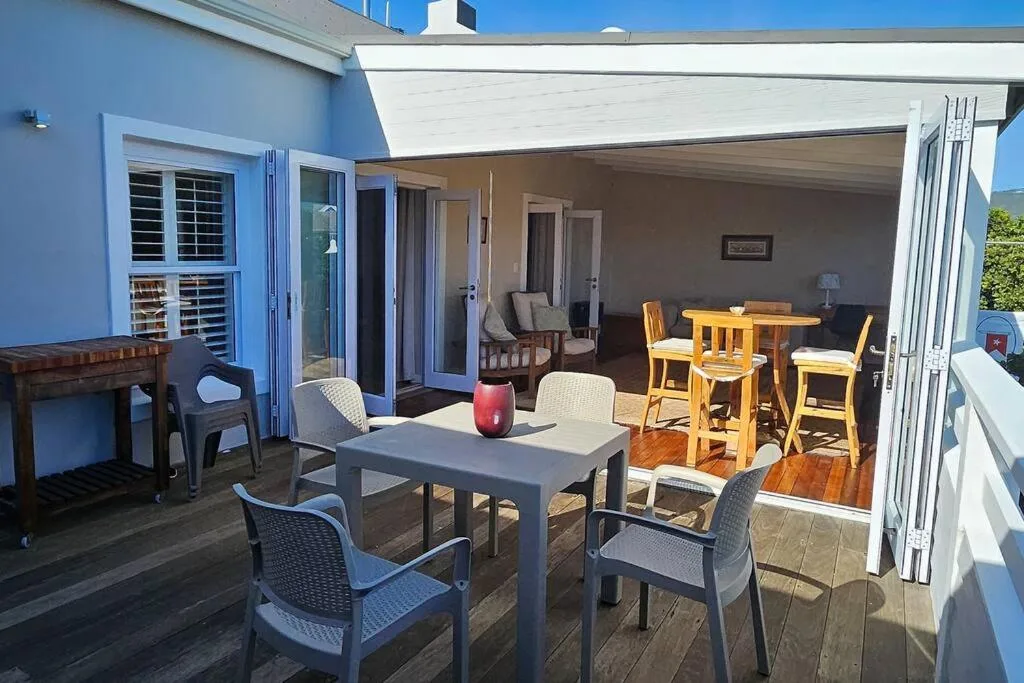Spacious covered deck with outdoor dining and lounge seating areas