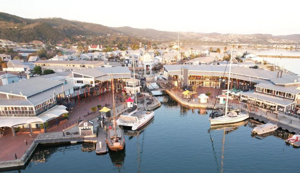 Scenic waterfront view of Knysna Quays with boats and distant hills