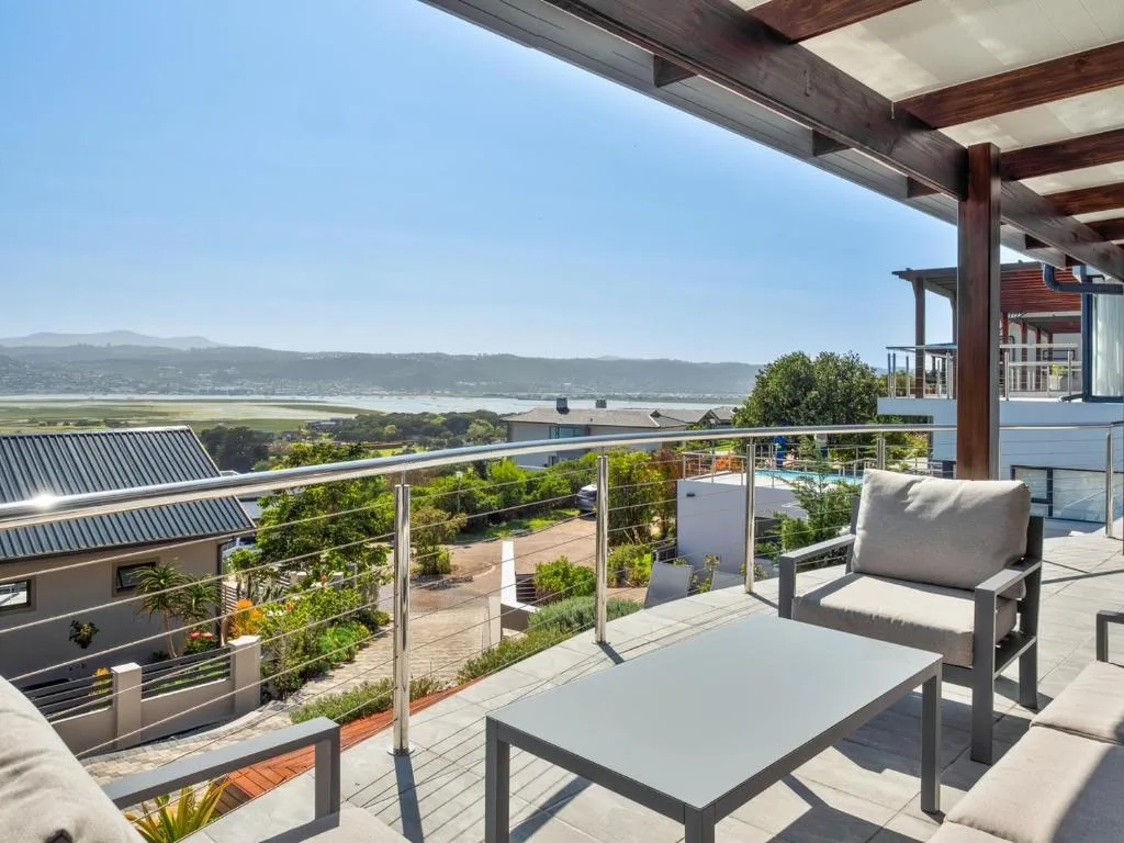 Elevated deck with seating overlooking Knysna Lagoon and surrounding landscape