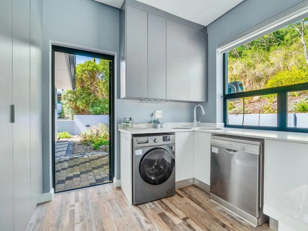 Modern kitchen with stainless steel appliances and garden view