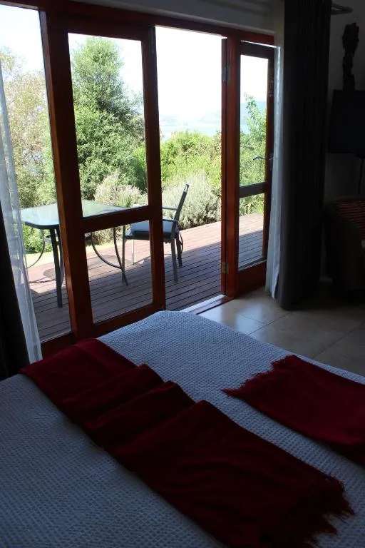 Wooden deck with outdoor seating and garden views beyond