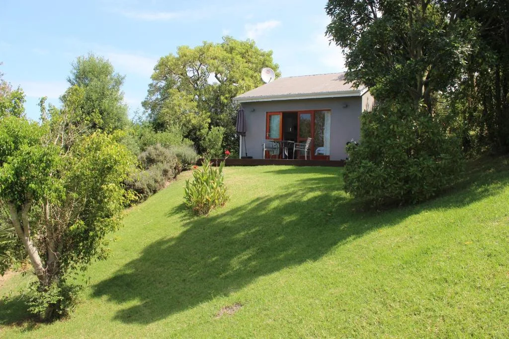 Charming cottage with manicured garden and shaded patio seating area