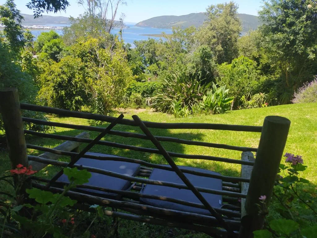 Scenic lagoon and mountain views through lush gardens and native trees