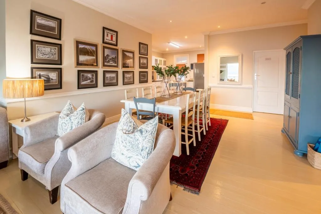 Open-plan dining and lounge area with framed artwork and elegant furnishings