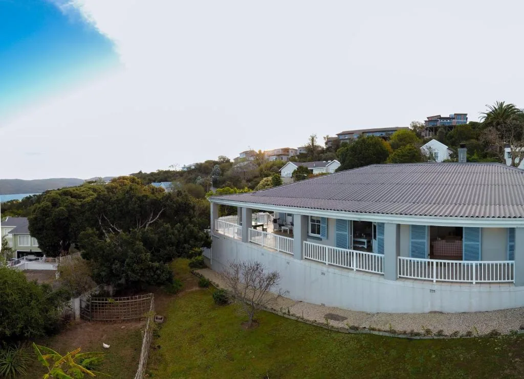 Light blue holiday home with wraparound deck overlooking Knysna lagoon and hills