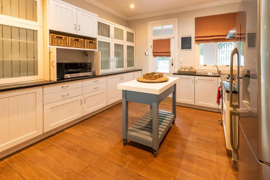 Modern kitchen with white cabinetry, island bench, and stainless steel appliances