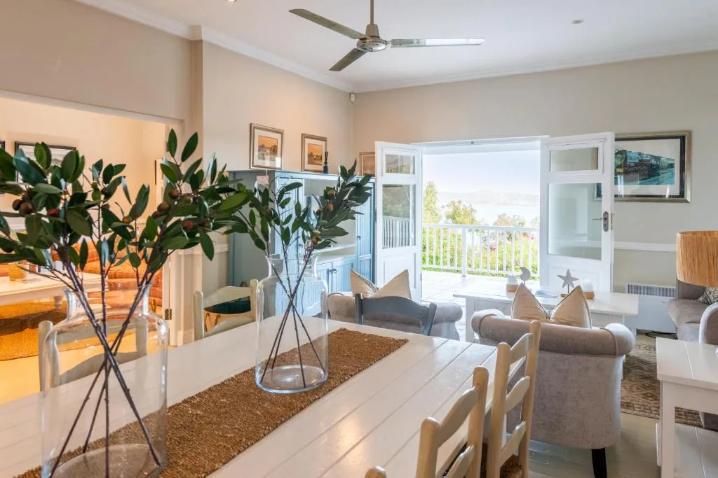 Bright open-plan lounge with comfortable seating and deck access beyond