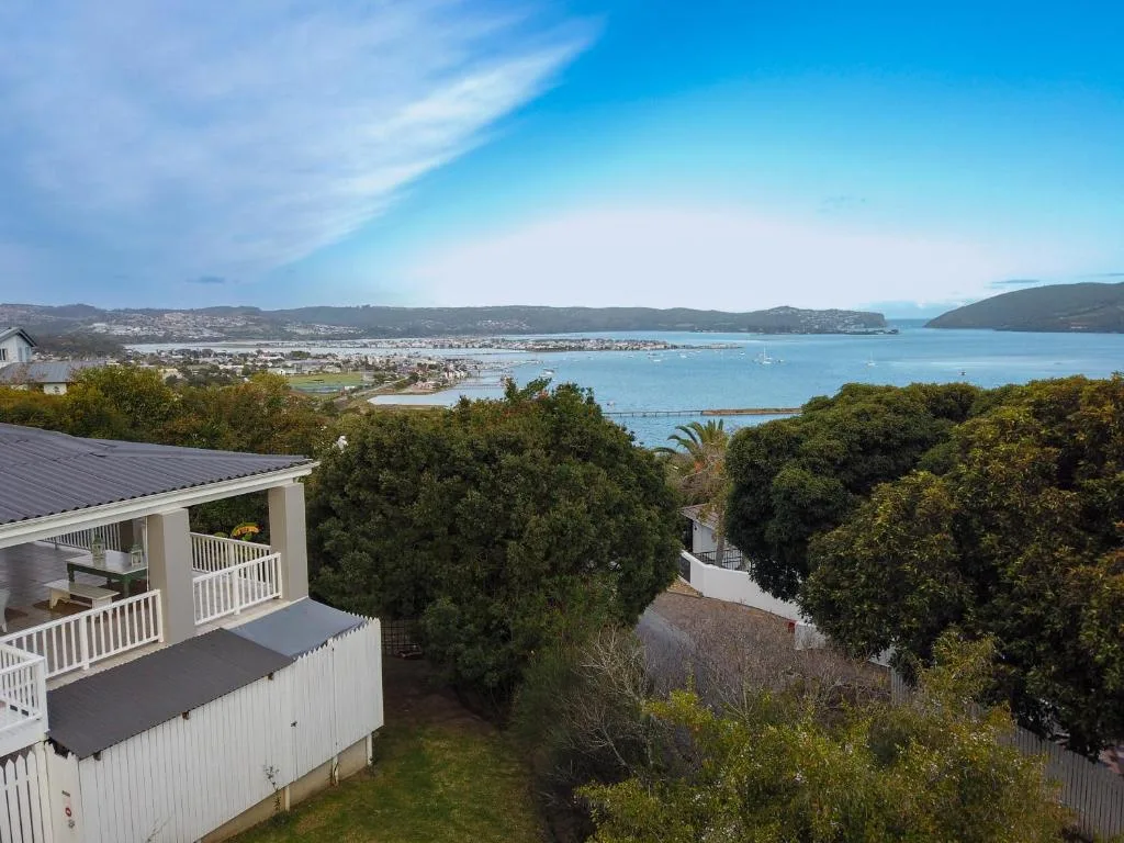 Stunning lagoon vista with mountains, town, and sailboats from property