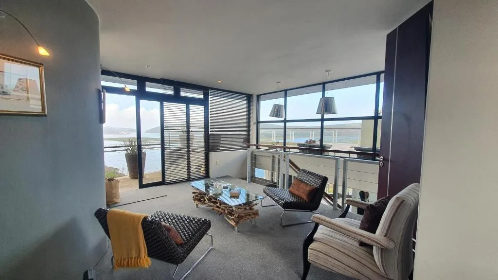 Modern lounge with contemporary furniture overlooking lagoon views through large windows