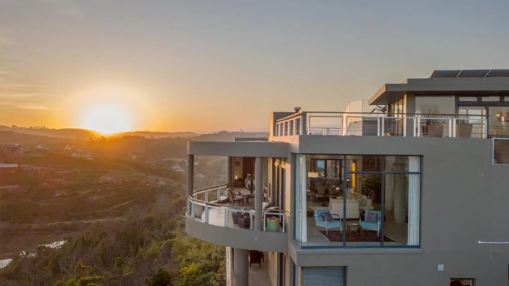 Sunset over Knysna valley from modern villa with deck and lagoon vista