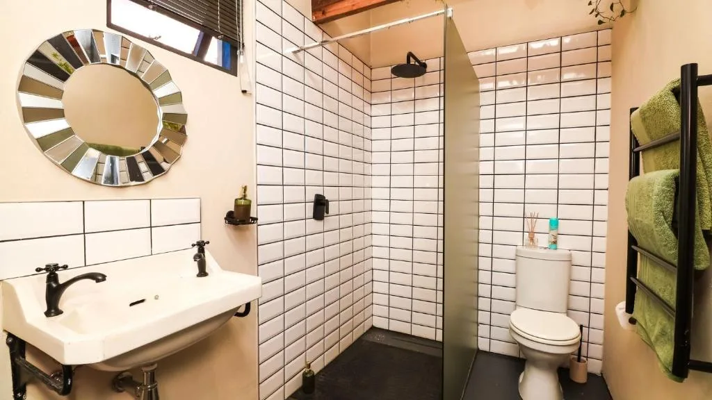 Modern bathroom with white subway tiles, vanity sink, and heated towel rail
