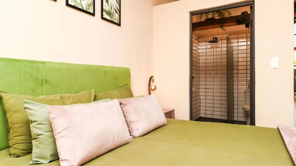 Bright bedroom with lime green headboard and soft pink pillows