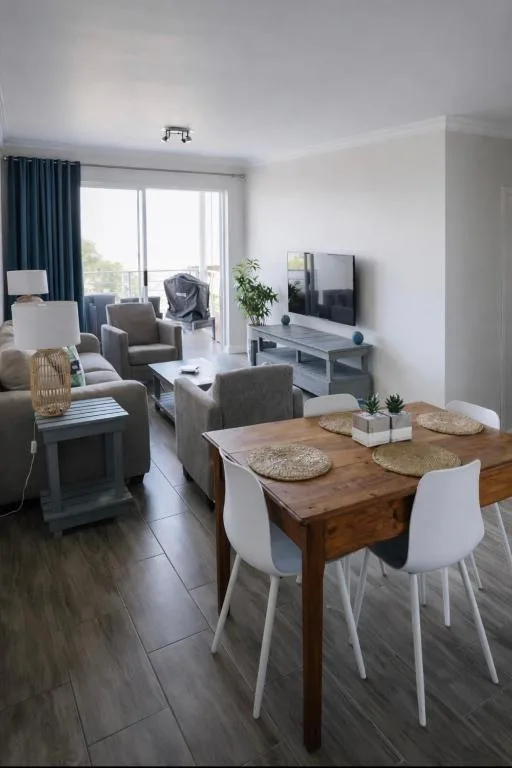 Open-plan lounge and dining area with comfortable seating and wooden table
