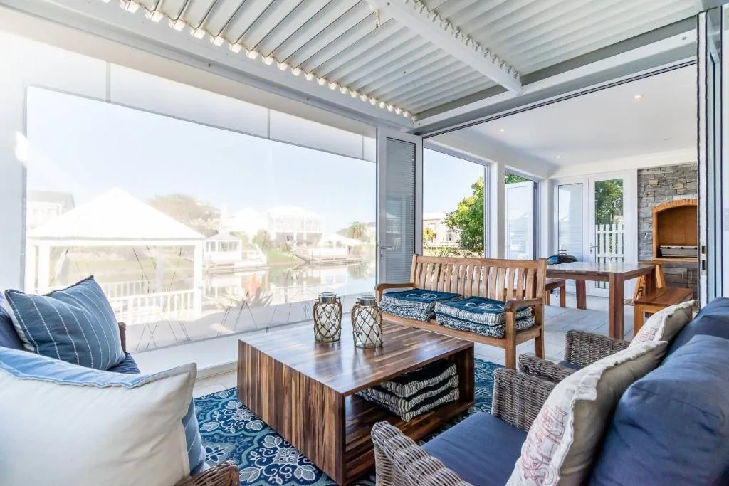 Covered deck with seating, views over canal and neighboring properties