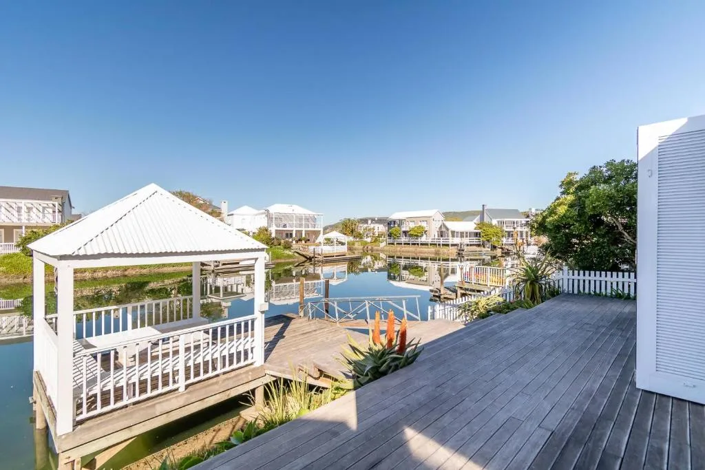 Waterfront deck with gazebo overlooking canal and neighboring properties