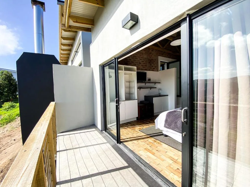 Modern patio with sliding glass doors overlooking contemporary accommodation