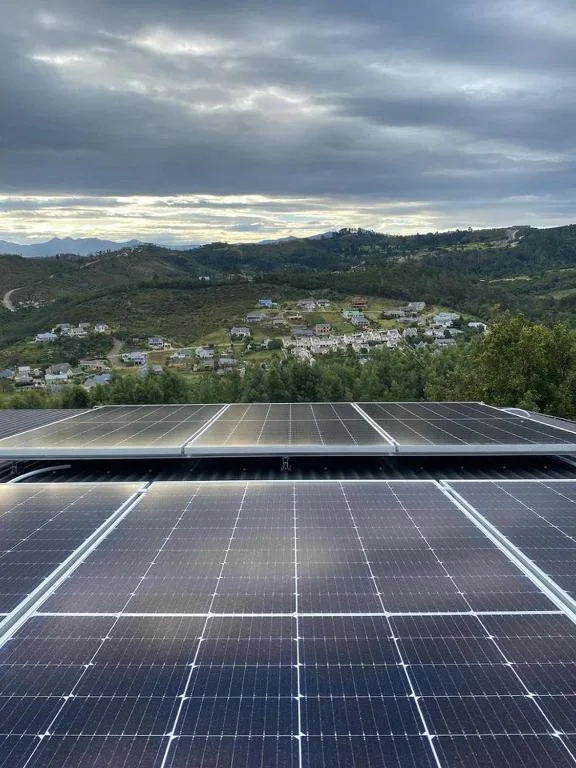 Solar panels on roof with scenic valley and mountains view
