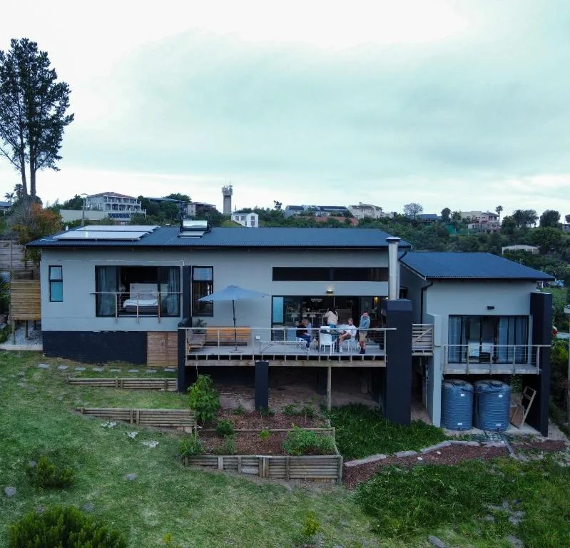 Modern self-catering home with deck, solar panels, and garden in Knysna
