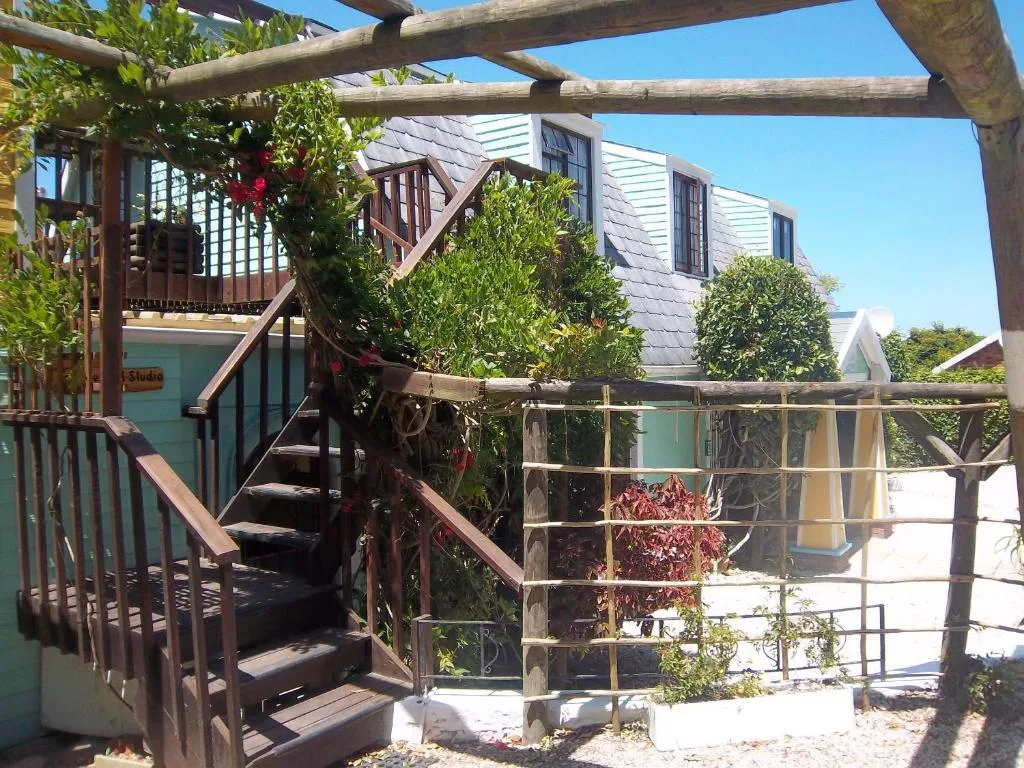 Wooden pergola and stairs with climbing plants overlooking property grounds