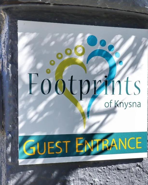 Footprints of Knysna guest entrance sign with colorful footprint logo