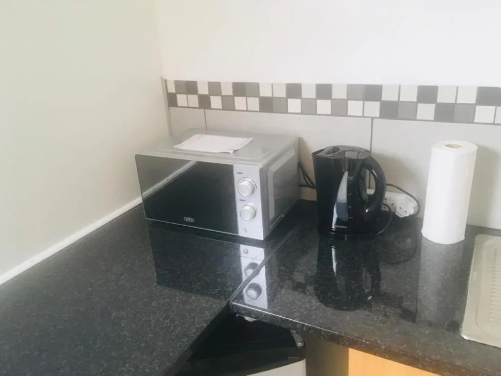 Kitchen counter with microwave, kettle, and small appliances
