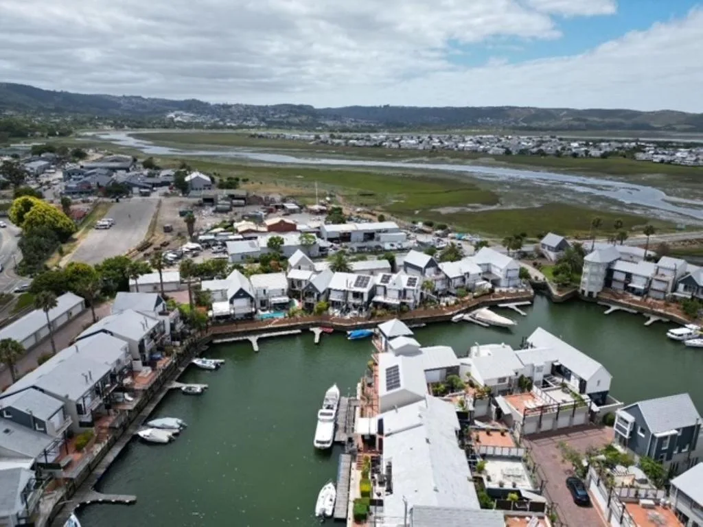 Aerial view of Knysna lagoon with waterfront properties and boats