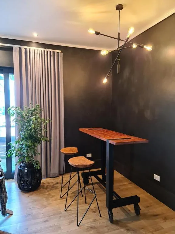 Modern dining counter with wooden top and bar seating for two