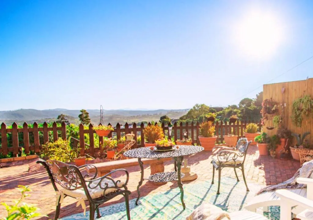 Expansive brick patio with ornate seating and scenic mountain valley views