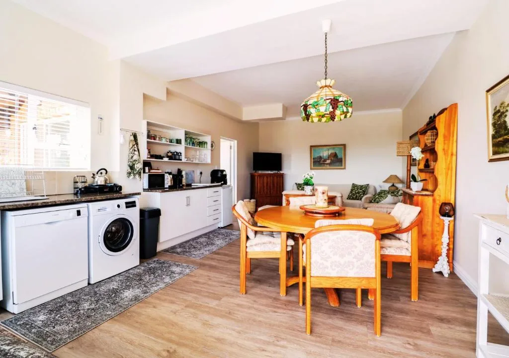 Open-plan living area with dining table, kitchen, and seating space