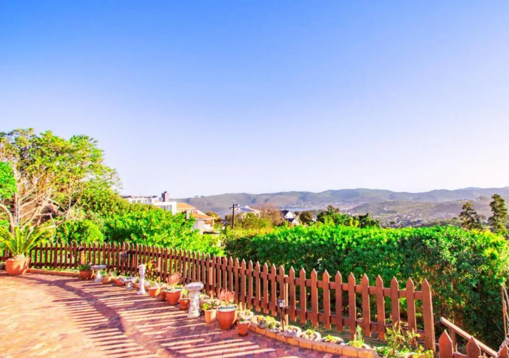 Scenic mountain landscape with lush green valleys and distant hills from property deck