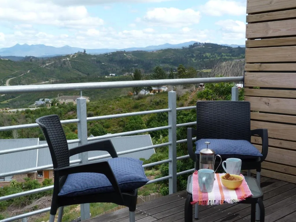 Mountain and valley landscape vista from elevated deck with seating